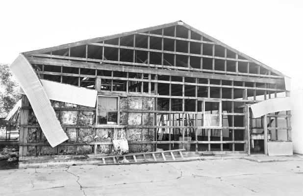 THE FORMER WOLBACH VILLAGE SHOP at 302 Center Avenue sits stirpped to its frame on Monday evening as work continues on what will become an addition to the fire hall. The lot was purchased from the Village of Wolbach by the Wolbach Suburban Rural Fire District for $50,000 on January 2nd of this year. The village has relocated its shop across the street, to the red shed at 203 Center Avenue, which it purchased from Mike and Cindy Rother.