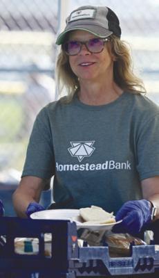 PATTY WROBLEWSKI helped serve Sunday evening’s barbecue, which was hosted by Homestead Bank.