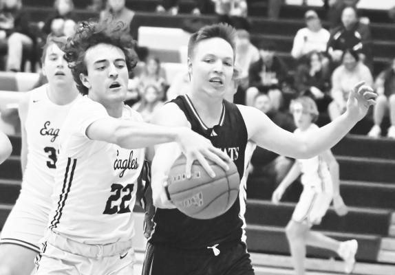 ST. PAUL’S BRAXTON HEATER fights for a rebound during the first quarter of last Thursday night’s boys basketball game between the Wildcats and Wood River Eagles. Photos by Michael Happ