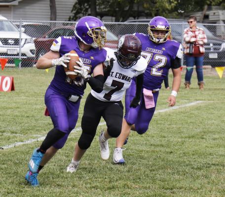ELBA’S BRENDON KEENE looks for a receiver downfield during Friday afternoon’s game against St. Edward. The Beavers ended up topping the Bluejays 67-18. (Michael Rother)