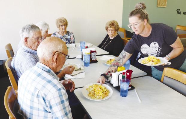 JEWELL HOWELL, owner of the The Den, serves up breakfast last Thursday morning. Photo by Michael Rother