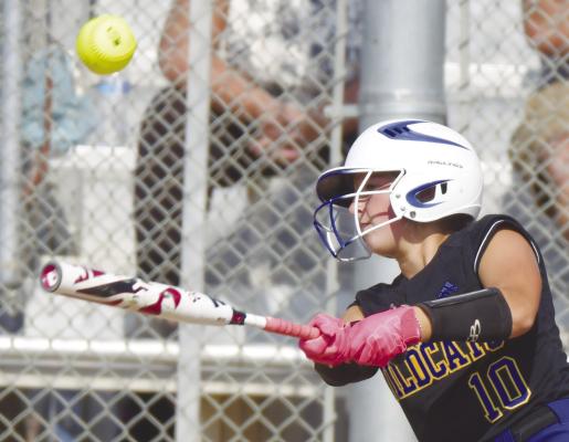 ST. PAUL’S ALLI DUGAN makes contact during last week’s second game between the Wildcats and the Cavaliers. Dugan had hits in both of last week’s district final games in Wahoo. Photo by Michael Happ