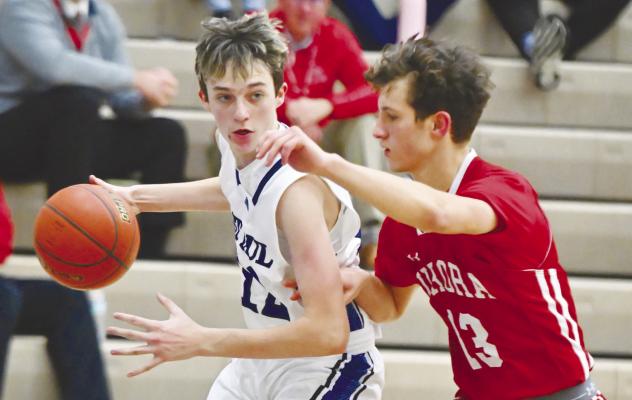 MADDOX QUINN threads his way past Aurora’s defense on Thursday night on his way to the paint. Quinn had two points in St. Paul’s 55-28 loss to the Huskies. Photo by Michael Happ