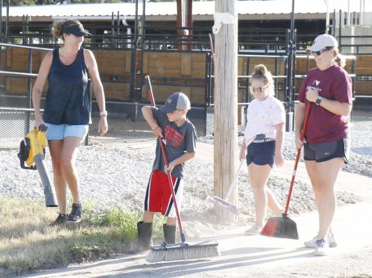LENDING A HAND during the Howard County Fair’s cleanup night were Sherise Loeffelbein, Easton Meyer, Marissa Janda, and Becky Meyer. A large crowd turned out to help at the annual pre-fair event on Monday night. (Courtney Leth)