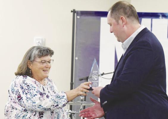 JULIE DUSH, who was honored as the St. Paul Area Chamber of Commerce’s Volunteer of the Year, receives her award from St. Paul Chamber Board President Jake Lawver. Photos by Michael Happ