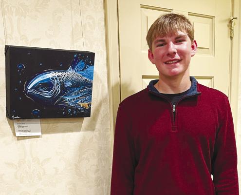 ST. PAUL HIGH SCHOOL junior Brecken Kavan is pictured next to his piece, titled Fluorescent Fish, which was installed as a part of the My Life in Nebraska Exhibit at the Nebraska Governor’s Residence earlier this month. Courtesy Photo