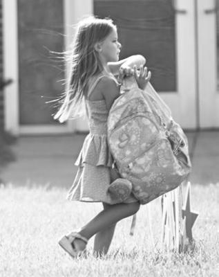 KIDS OF ALL AGES, including Oaklyn Hitchler capitalized on last Tuesday night’s back-to-school event at St. Paul Public Schools to tote their new year’s worth of school supplies to their lockers and classrooms. Photo by Michael Happ