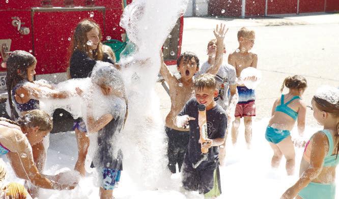 BUBBLES showered down on main street on Sunday courtesy of Wolbach Volunteer Fire and Rescue. Large groups of kids enjoyed the fun between the turtle and duck races.