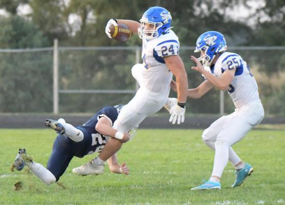 RYKER GOETTSCHE stretches out for some additional yardage during the first quarter of Friday night’s game between St. Paul and Adams Central. The Patriots ended up topping the Wildcats last week 34-3. (Michael Happ)