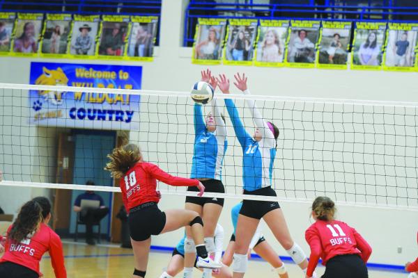 ST. PAUL seniors Maya Becker and Jenna Jakubowski block a shot from Gibbon during the first set of last week’s match against the Buffaloes. The Wildcats swept their guests 25-11, 25-10. (Michael Happ)
