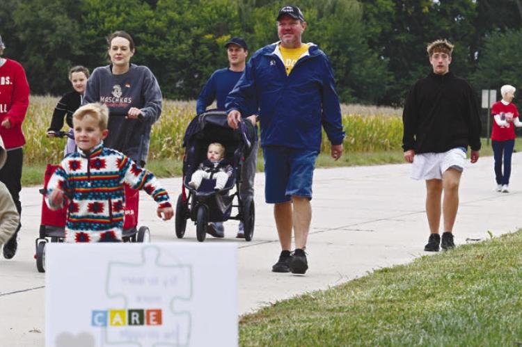 THE ST. PAUL CARE TEAM’S fourth annual Mental Health Mile event attracted participants of all ages on Sunday afternoon. Above, walkers make their way up Taylor Street during the first leg of the walk. Photos by Michael Happ