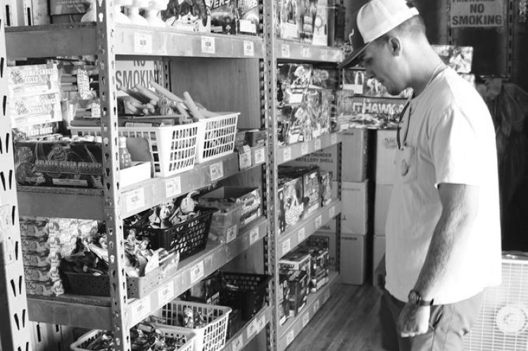 FIREWORKS SALES kicked off in St. Paul over the weekend, with vendors opening their booths to customers on Sunday for the first time. Above, Cole Epp browses the offerings at Peter’s Poppers near the Pizza Hut in St. Paul on Monday afternoon. Firework sales run through the Fourth of July. Photo by Michael Rother