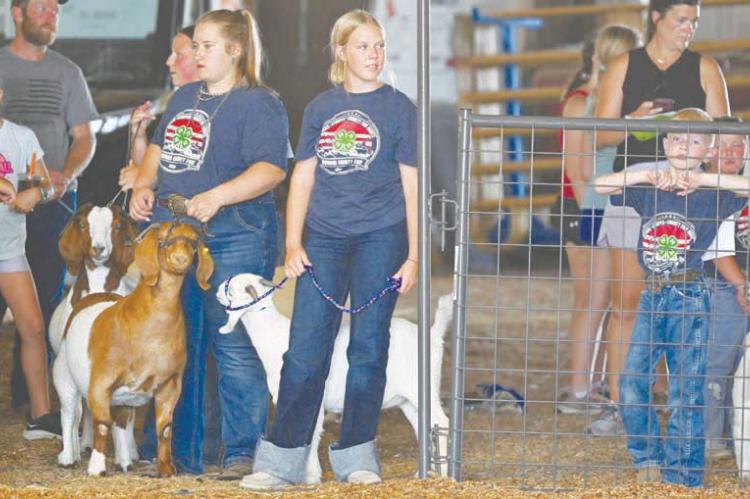 EXHIBITORS wait to enter the show ring prior to the start of Sunday afternoon’s Howard County Fair 4-H Goat Show. A large number of goat and sheep showmen participated in the event earlier this week, despite the extreme heat. Photos by Michael Happ