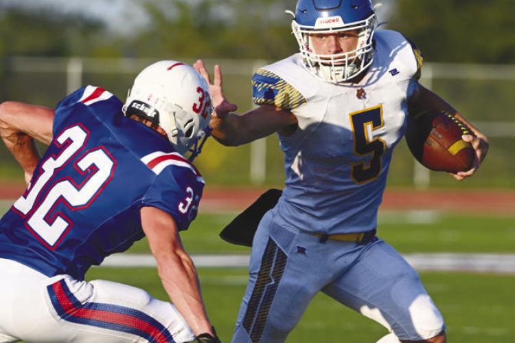 ST. PAUL’S MASON MAJERUS skirts past a Palmyra defender on his way to the end zone for the Wildcats’ first touchdown of the 2026 season. St. Paul beat Palmyra 25-14 for their first win of the year on Friday. Photo by Michael Happ