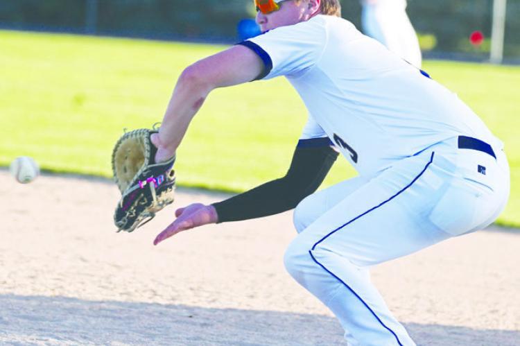 BRAXTON HEATER attempts to pick up an out at first base during a game earlier this summer. The Post 119 Seniors had won five straight games through the weekend. Photo by Michael Happ