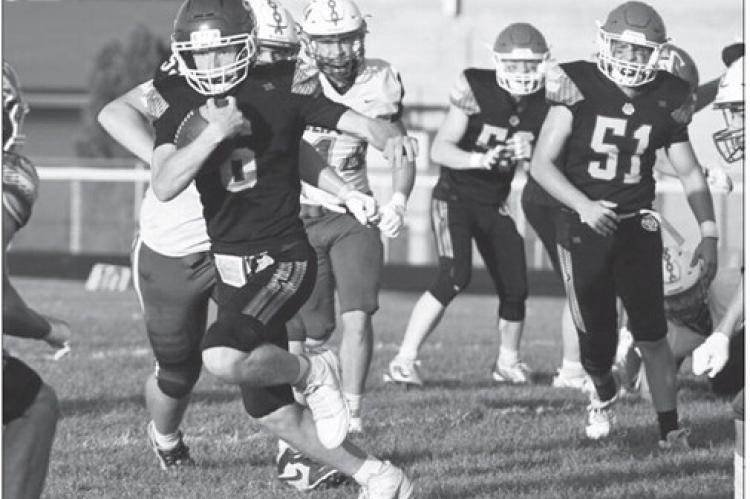 JACKSON WEGNER finds a hole in the Clippers’ defense and cuts upfield during the first quarter of last week’s game against Malcolm. Photos by Michael Happ