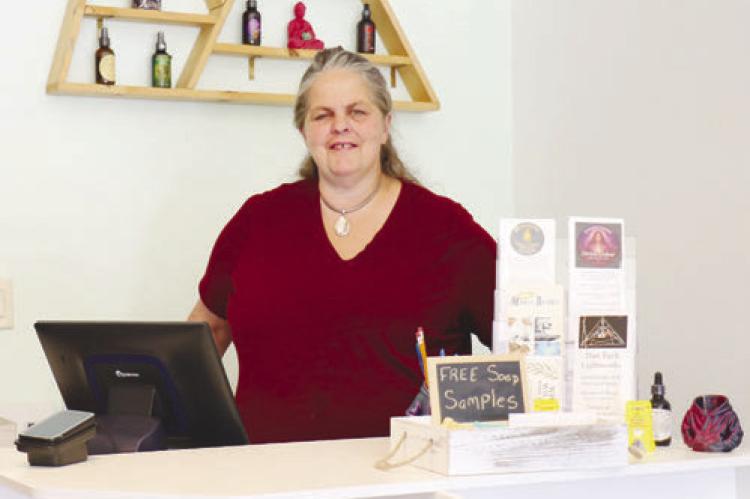 KATANA RAY stands behind the counter of Running Wolf Originals’ new storefront shop in St. Paul last week. The St. Paul location officially opened on June 19th. Photo by Michael Rother