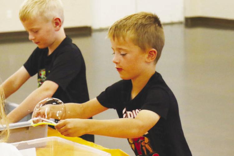 KIDS OF ALL AGES got the opportunity to learn a bit about cell membranes as part of St. Paul Summer Rec’s Summer Science programming last Wednesday, June 17th. Pictured are Greyson Knapp and Jack Meyer. Photos by Michael Rother