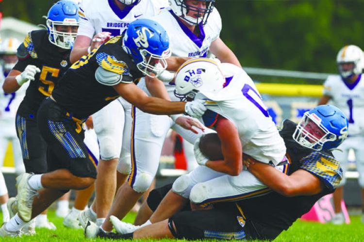 ST. PAUL’S COLTON KUSZAK AND JOEL KASLON work to bring down Daxton Malcolm during last Friday’s game against Bridgeport. Photo by Michael Happ