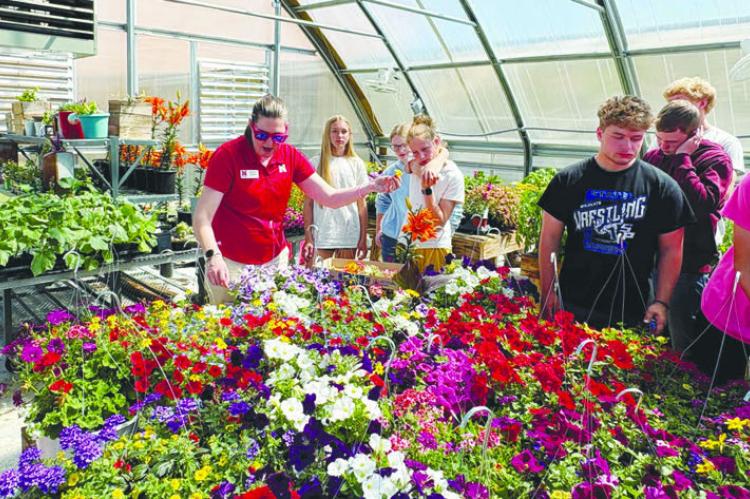 NEBRASKA EXTENSION EDUCATOR ELIZABETH EXSTROM speaks to St. Paul Public School students in the school’s greenhouse prior to the FFA plant sale earlier this year. Courtesy Photos