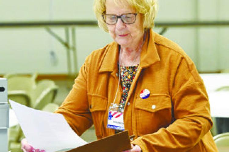 POLL WORKER MARLENE CASPERSEN helped man the polling site at Boelus during the Tuesday, May 12th primary election. Photo by Michael Happ