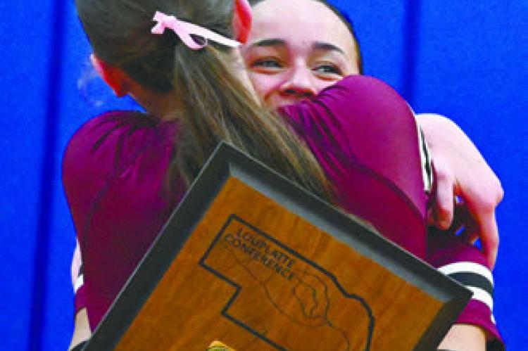 CENTURA’S TAYA TAUKIUVEA embraces Kennedy Davis after the Centura volleyball team won a five-set match over St. Paul to claim the school’s first-ever LouPlatte Conference Volleyball Championship last Thursday night. Photo by Michael Happ