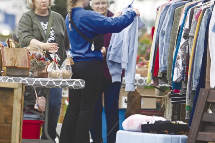 PARTICIPANTS in the twenty-third annual Junk Jaunt browse the many items being sold at the home of Alice Osterman-Davis in St. Paul on Saturday morning. Photos by Michael Happ