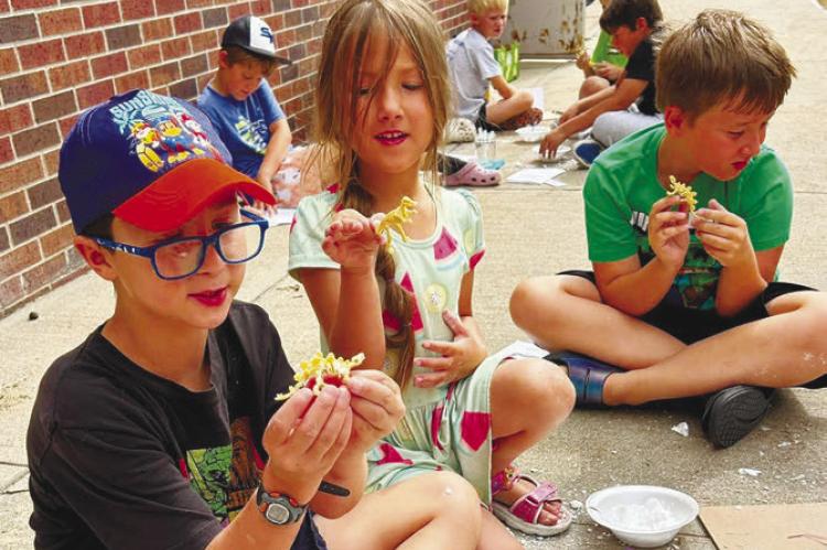 PARTICIPANTS in the St. Paul Library’s annual summer reading program worked to Unearth a Story with a multitude of crafts and activities during the month of June. Above, students show off their fossils during one of the last gatherings of the summer. Courtesy Photo