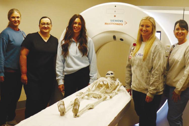 HOWARD COUNTY MEDICAL CENTER recently purchased a new CT machine. Pictured with the machine in the medical center’s new CT suite are Brandie Rosander, Mariah Quiring, Autumn Wegner, Nicole Coufal, and Holly Sack. Photo by Michael Rother