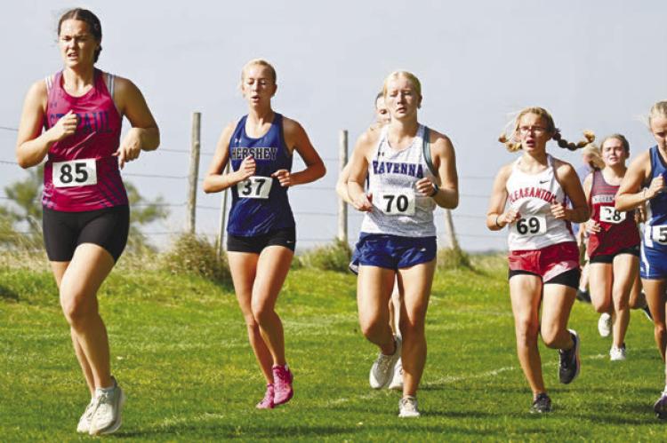 KATIE KLEINSASSER battles for position on Thursday at the Ravenna Invitational. Kleinsasser placed forty-eighth at the Bluejays’ meet. Photos by Michael Happ
