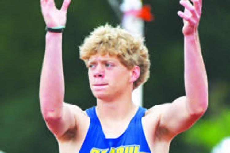 ST. PAUL’S CONNER DOUTHIT works to get the crowd cheering for him during the boys’ triple jump on Friday morning. Photos by Jordan Coslor and Michael Happ