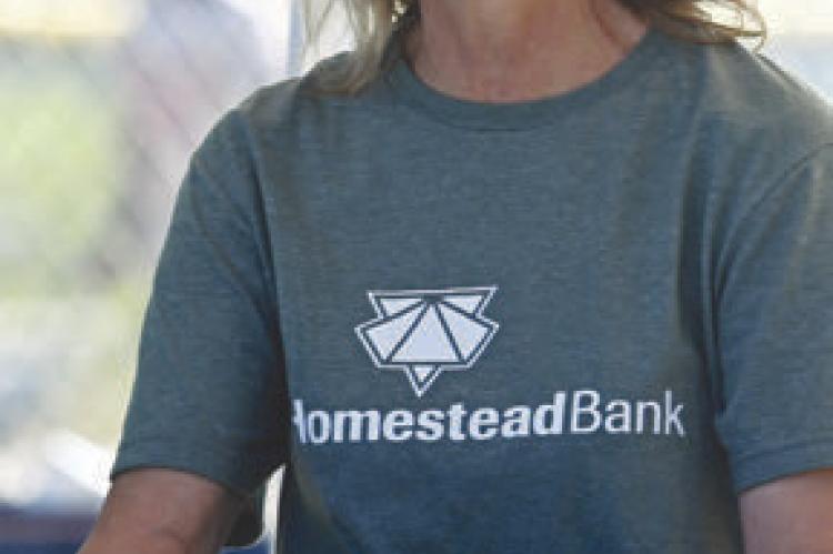 PATTY WROBLEWSKI helped serve Sunday evening’s barbecue, which was hosted by Homestead Bank.