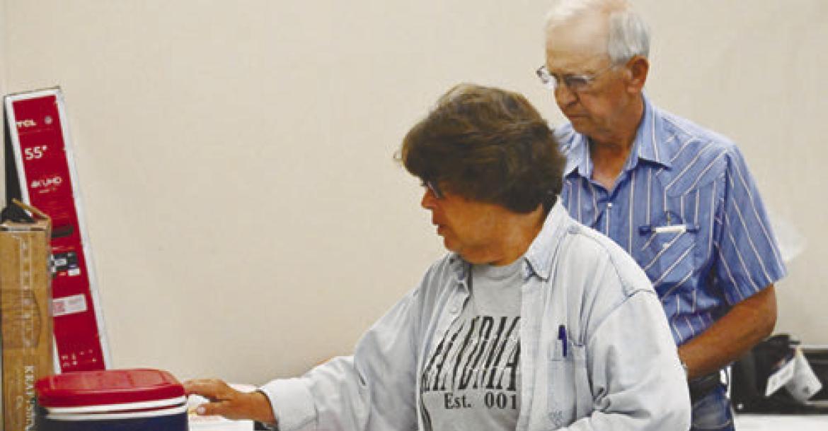 CAROL AND SKEETER STEPANEK browse the bevy of raffle items during last week’s pancake feed hosted by the St. Paul Volunteer Fire Department and Rescue Squad.