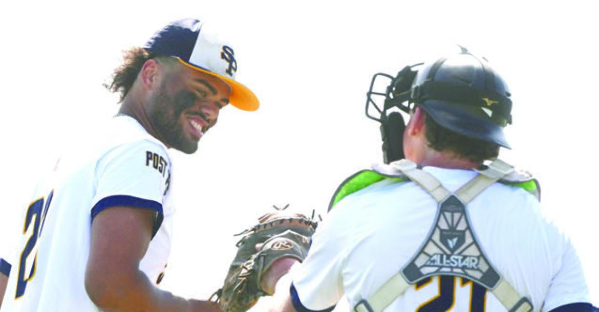 ST. PAUL POST 119 SENIORS Levi Bader and Carter Hawley exchange lighthearted humor prior to Bader taking the mound during a game earlier this season.