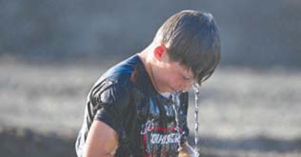 MAVERICK CURRUTHERS fishes for a washer during Sunday’s Barnyard Olympics at the Howard County Fair.