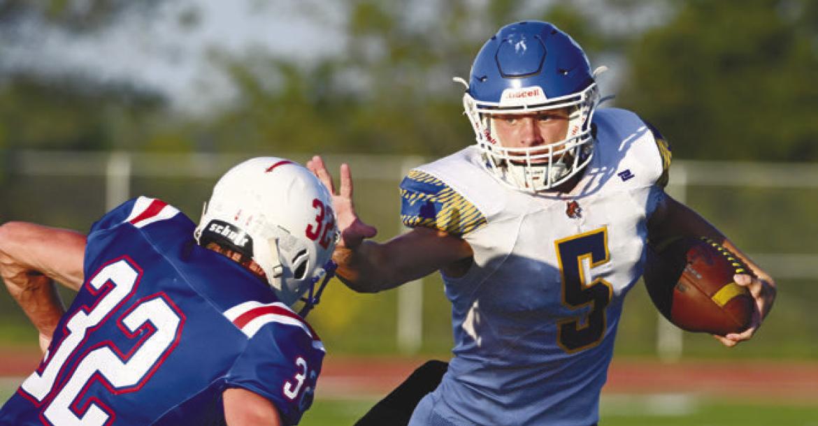 ST. PAUL’S MASON MAJERUS skirts past a Palmyra defender on his way to the end zone for the Wildcats’ first touchdown of the 2026 season. St. Paul beat Palmyra 25-14 for their first win of the year on Friday. Photo by Michael Happ