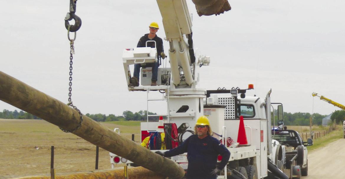 CREWS with Howard Greeley Rural Public Power District—including Cody Kaczor and Robert Svoboda—work to repair power infrastructure in southern Howard County following last month’s destructive tornado. Courtesy Photo