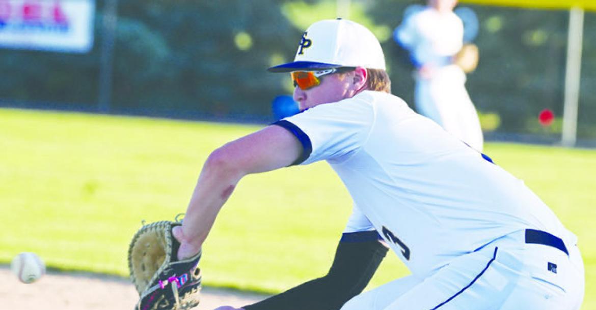 BRAXTON HEATER attempts to pick up an out at first base during a game earlier this summer. The Post 119 Seniors had won five straight games through the weekend. Photo by Michael Happ