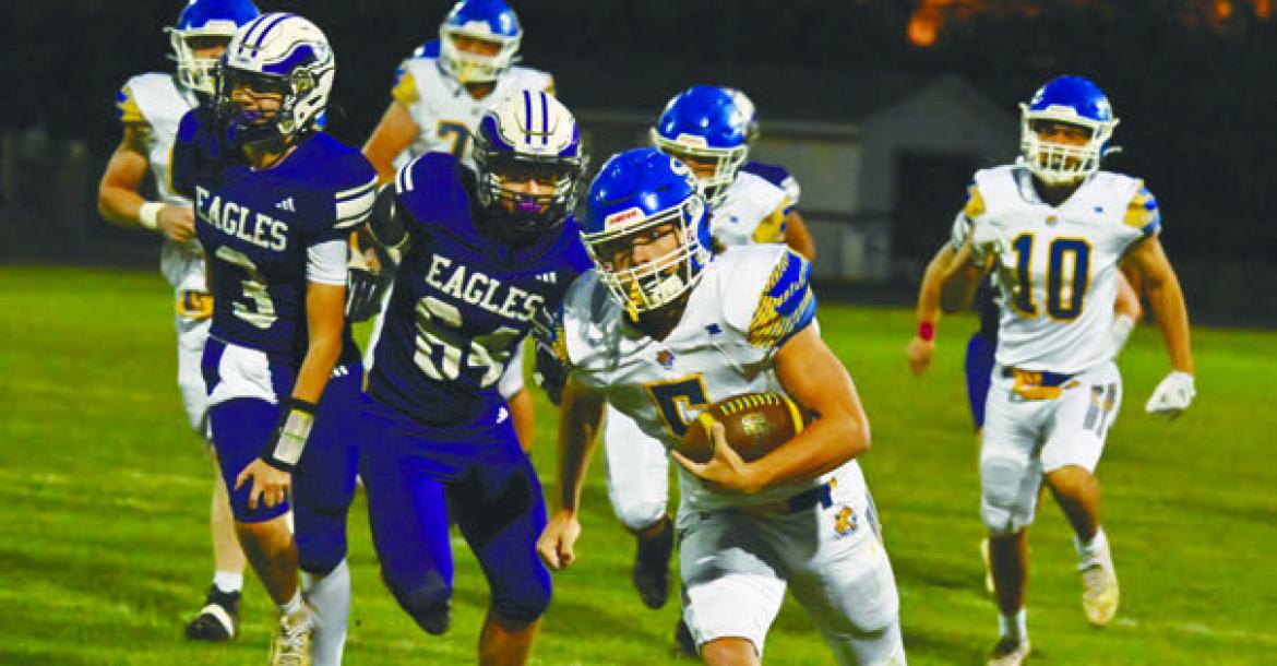 ST. PAUL SENIOR MASON MAJERUS breaks free for a big gain during the first quarter of Friday night’s game against Wood River. Majerus surpassed 1,000 career rushing yards during the last game of his career. Photo by Michael Happ