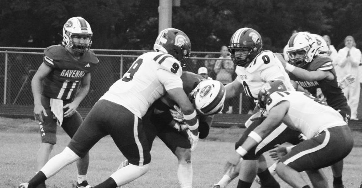 CENTURA DEFENDERS Luis Flores, Jayce Campbell, and Christian Iron Horse work to bring down a Ravenna ball carrier on Friday night. Photos by Monte Steele
