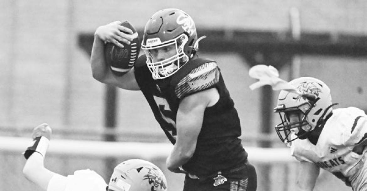 ST. PAUL’S MASON MAJERUS muscles his way past a pair of Summerland defenders on Friday afternoon. The Bobcats beat the Wildcats 24-20, forcing St. Paul to 3-2 on the season. Photos by Michael Happ
