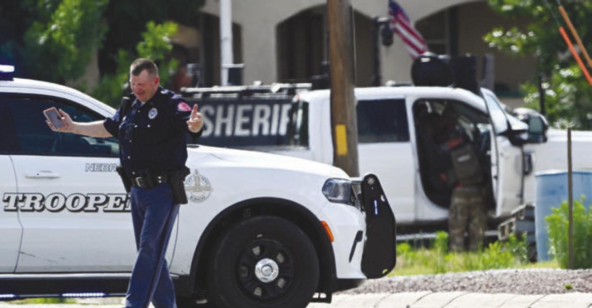 A TROOPER with the Nebraska State Patrol helps direct traffic at the corner of Grand and 6th streets in St. Paul as members of the Central Nebraska Special Response Team executed a search warrant at a nearby property. Photo by Michael Happ