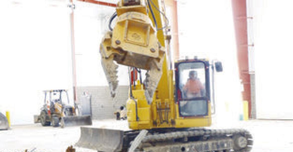KIM JENSEN separates metal from municipal waste with a picker at the Loup Central Landfill Association.