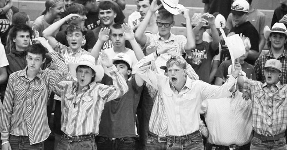 MEMBERS of the St. Paul High School student body got into the action late last month during the Wildcat volleyball team’s season opener against David City High School. The students dressed in their best cowboy attire, helping the Blue and Gold lasso a victory on the court. Photo by Michael Happ