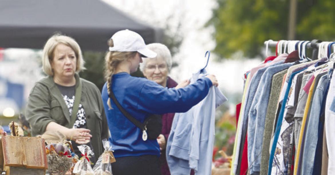 PARTICIPANTS in the twenty-third annual Junk Jaunt browse the many items being sold at the home of Alice Osterman-Davis in St. Paul on Saturday morning. Photos by Michael Happ