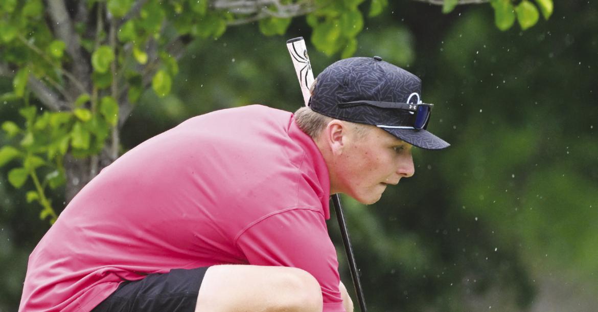 JACKSON WEGNER lines up a putt on the fifth green of the front nine at Indianhead Golf Club on Thursday.