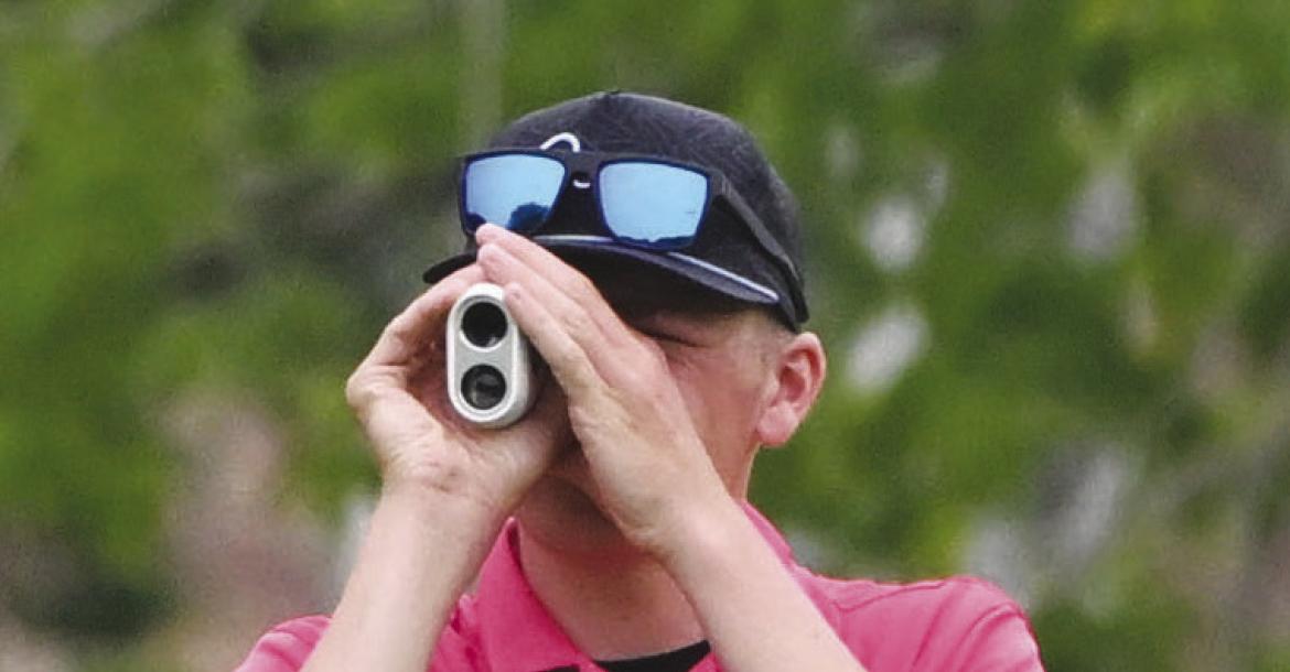 JACKSON WEGNER measures the distance to the green on the ninth hole at Indianhead Golf Club.