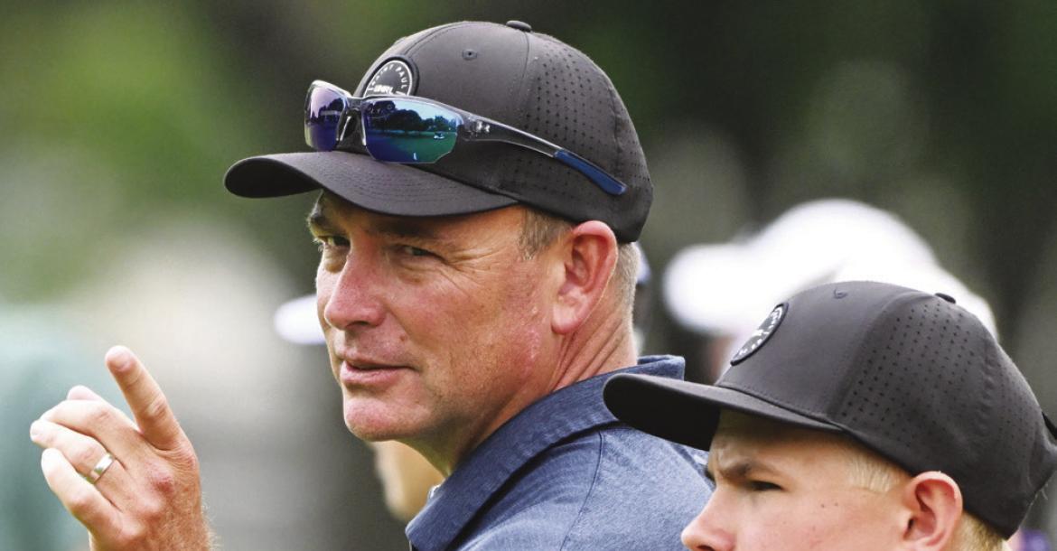 ST. PAUL HEAD COACH ROB WEGNER shares a lighthearted moment with Casen Kavan on the eighteenth hole on Thursday.