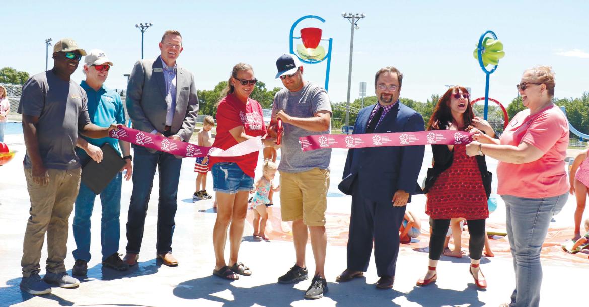 CUTTING THE RIBBON on Wolbach’s new playground and splash pad project last Thursday were Mario Robinson, Larry Steele, Josh Jelden, Shelby Steenson, Matt Steenson, Jerad Reimers, Chelsea Egenberger, and Carla Kimball. Photo by Michael Rother