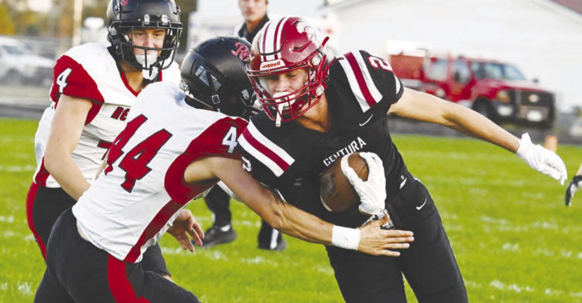 CENTURA’S FLETCHER FRIES edges past Arcadia/Loup City’s Austin Conner during Friday night’s game at Centura High School. Fries had a pair of runs in the contest, which the Centurions won 44-14. Photo by Michael Happ